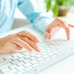 Female hands or woman office worker typing on the keyboard