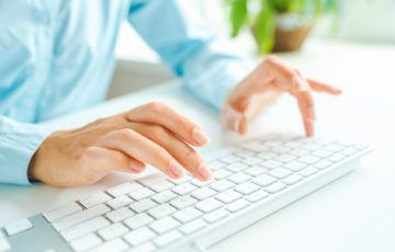 Female hands or woman office worker typing on the keyboard