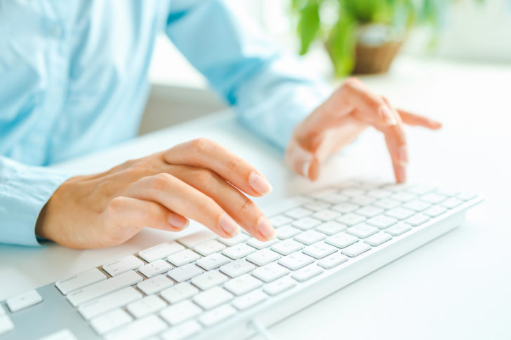Female hands or woman office worker typing on the keyboard