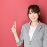 portrait of asian businesswoman pointing on red background